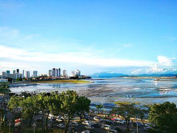 Scenic view of sea and buildings against sky