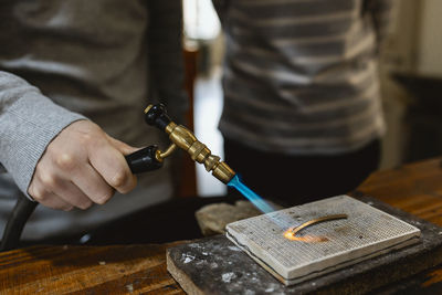 Midsection of man working at workshop