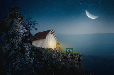 Digital composite image of illuminated building against sky at night