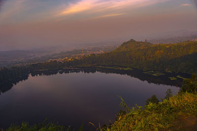 Scenic view of lake against sky during sunset