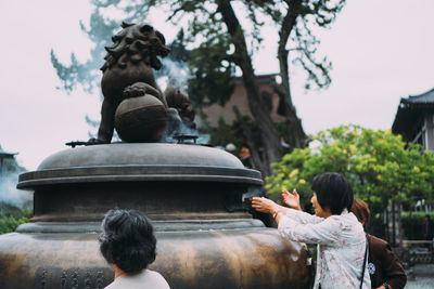 Rear view of a statue against sky