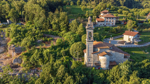 High angle view of trees and houses against buildings
