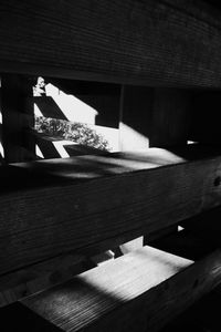 Close-up of wooden bench on table against building