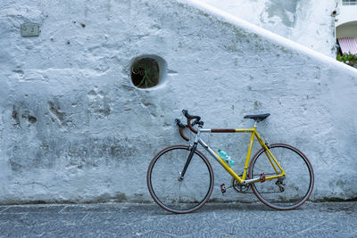 Bicycle leaning against wall