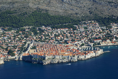 High angle view of townscape by sea