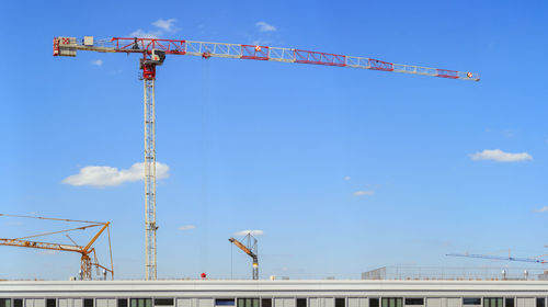 Low angle view of crane against sky