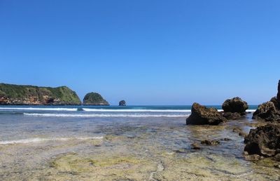 Scenic view of sea against clear blue sky