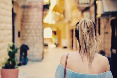 Rear view of woman on footpath