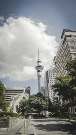 Buildings in city against cloudy sky