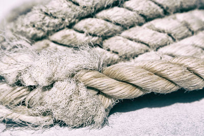 Close-up of rope tied up on wood