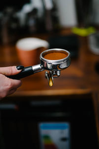 Close-up of hand holding coffee cup