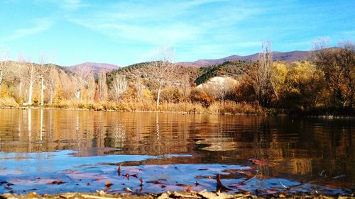 Scenic view of lake and mountains against sky