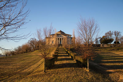 Steps on field against clear sky