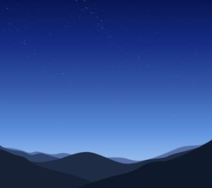 Low angle view of mountain range against blue sky at night