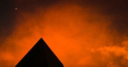 Low angle view of building against sky at sunset