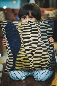 Close-up portrait of boy sitting at home