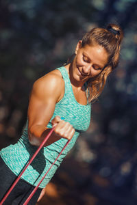 Female athlete exercising with resistance band at park