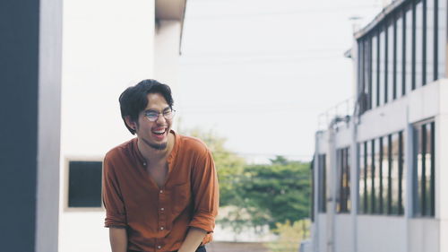 Young man standing against wall