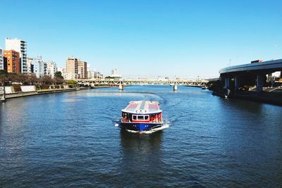 Boat in city against clear sky