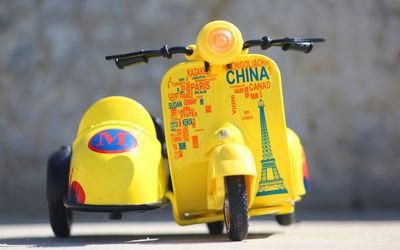 Close-up of yellow toy car on road
