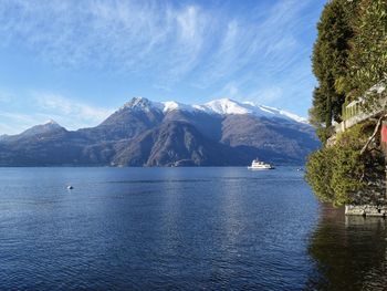 Scenic view of sea and mountains against sky