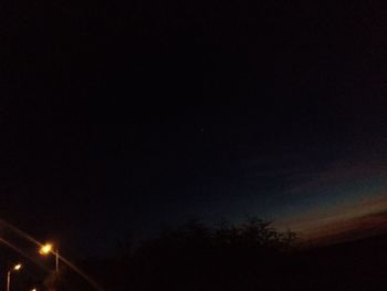 Low angle view of illuminated street light at night