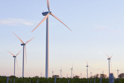 Wind turbines against sky