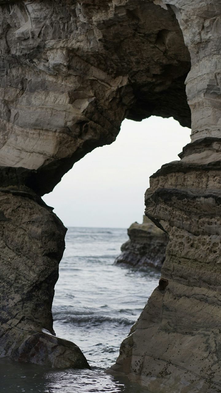 rock formation, sea, rock - object, water, scenics, beauty in nature, tranquility, rock, cliff, tranquil scene, nature, horizon over water, eroded, geology, physical geography, idyllic, rough, beach, sky, rocky