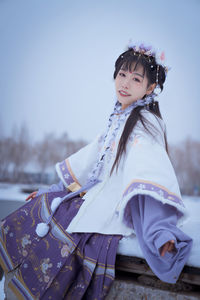 A girl in hanfu in the snow