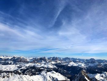 Scenic view of snowcapped mountains against blue sky