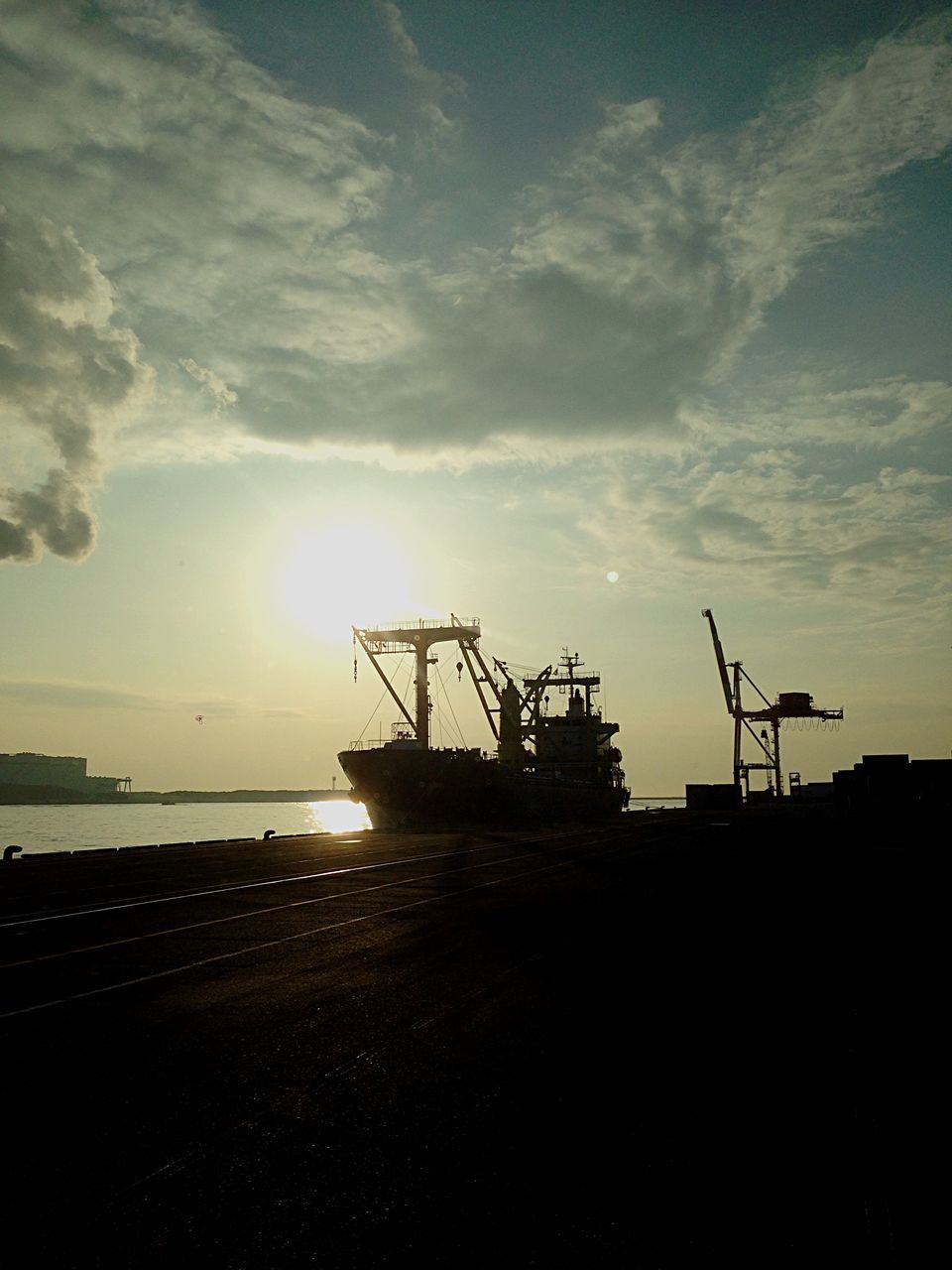 sea, sky, sunset, water, sun, silhouette, cloud - sky, crane - construction machinery, horizon over water, nature, sunlight, built structure, harbor, commercial dock, scenics, beauty in nature, tranquility, cloud, tranquil scene, outdoors