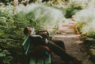 Side view of a young woman in forest