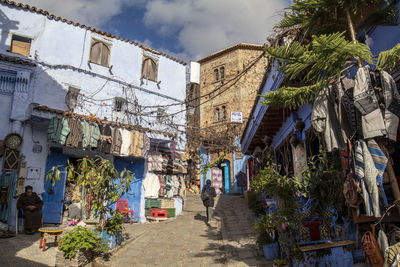 People walking on street amidst buildings in city