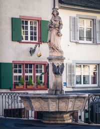 Statue outside house against building