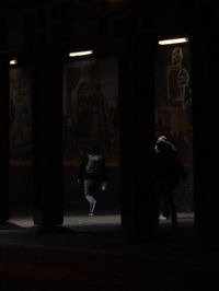 People walking in illuminated lights