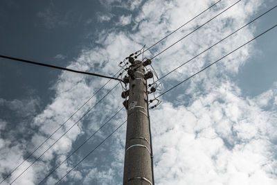 Low angle view of electricity pylon against sky