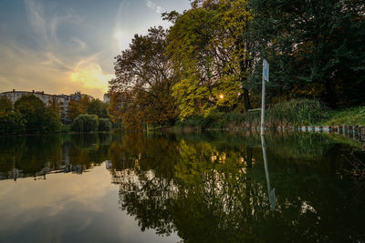 Scenic view of lake against sky at sunset