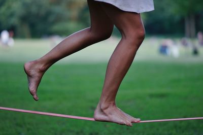 Low section of girl walking on rope