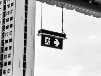 Low angle view of information sign against building