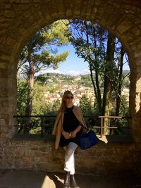 Smiling woman sitting in balcony