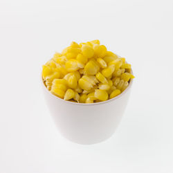 High angle view of fruits in bowl against white background