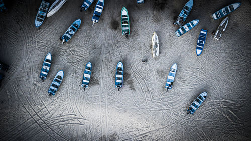Aerial view of boats moored on sand at beach