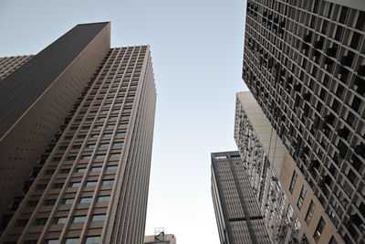 Low angle view of skyscrapers against clear sky