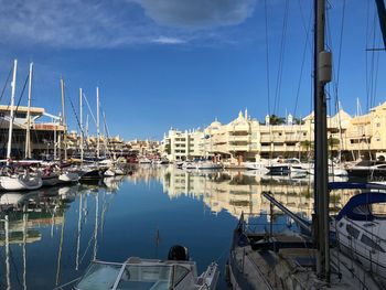 Boats moored at harbor in city