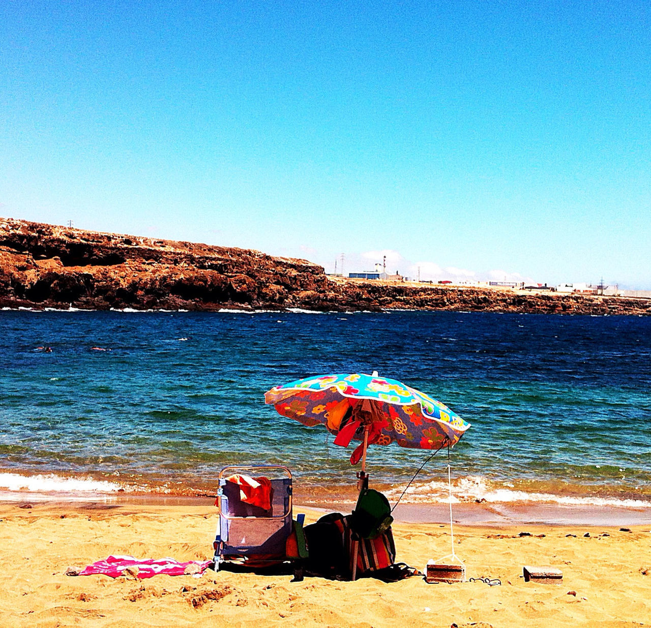 beach, clear sky, water, sea, blue, sand, shore, copy space, tranquil scene, tranquility, vacations, scenics, beach umbrella, relaxation, beauty in nature, nature, horizon over water, parasol, chair, sunlight