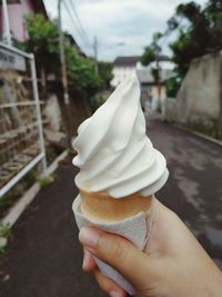 Close-up of hand holding ice cream cone