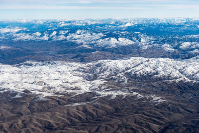 High angle view of snowcapped mountains against sky