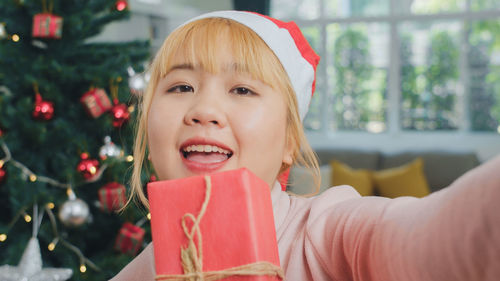 Portrait of woman with christmas tree