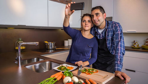 Young couple holding hands at home
