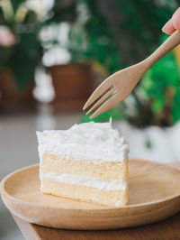 Close-up of fork over cake in plate